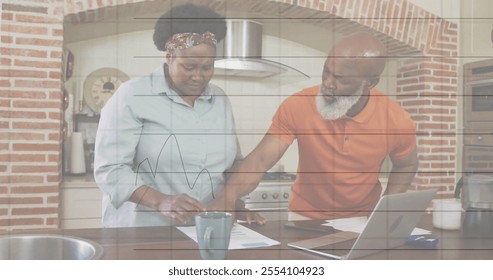 Image of financial data processing over senior african american couple using laptop. Senior lifestyle, finances, communication and digital interface concept digitally generated image. - Powered by Shutterstock