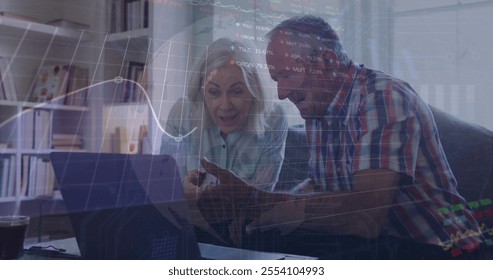 Image of financial data processing over senior caucasian couple using laptop. Senior lifestyle, finances, communication and digital interface concept digitally generated image. - Powered by Shutterstock