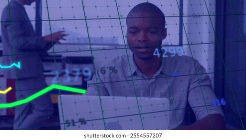 Image of financial data processing over african american businessman using laptop in office. Global finance, business, connections, computing and data processing concept digitally generated image. - Powered by Shutterstock