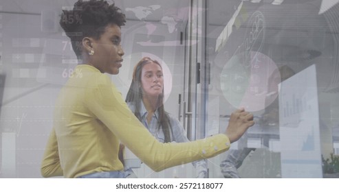 Image of financial data processing over diverse colleagues brainstorming in office. Global business, computing, communication and digital interface concept digitally generated image.