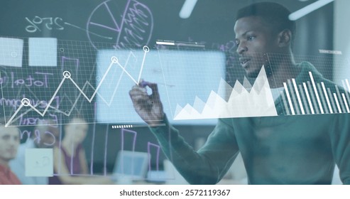 Image of financial data processing over african american businessman in office. Global finance, business, connections, computing and data processing concept digitally generated image.