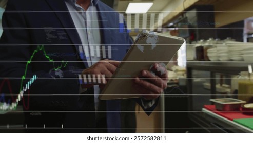 Image of financial data processing over caucasian man using tablet. Global finance, business, connections, computing and data processing concept digitally generated image.