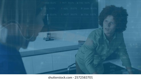 Image of financial data processing over diverse colleagues discussing work in office. Global business, finances, computing and digital interface concept digitally generated image.