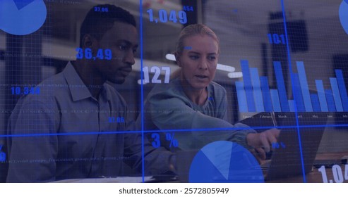 Image of financial data processing over diverse colleagues using laptop in office. Global finances, business and digital interface concept digitally generated image.