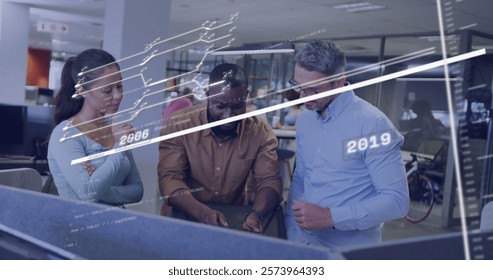 Image of financial data processing over diverse colleagues working in office. Global business, finances, computing and digital interface concept digitally generated image.