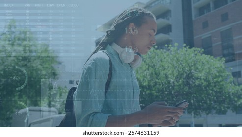 Image of financial data processing over biracial man using smartphone. Global business, finances, computing and data processing concept digitally generated image.