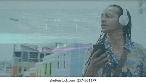 Image of financial data processing over biracial man using smartphone. Global business, finances, computing and data processing concept digitally generated image.