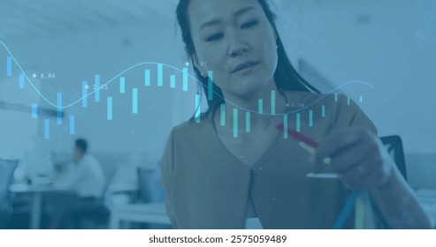 Image of financial data processing over biracial businesswoman in office. Global finance, business, connections, computing and data processing concept digitally generated image.