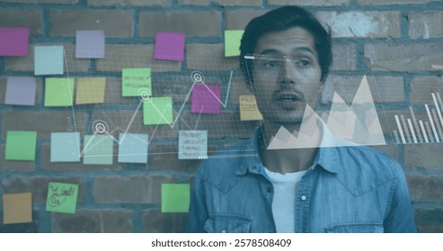 Image of financial data processing over biracial businessman in office. Global finance, business, connections, computing and data processing concept digitally generated image.