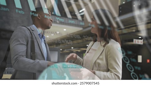 Image of financial data processing over diverse colleagues discussing work in office. Global business, finances, computing and digital interface concept digitally generated image.