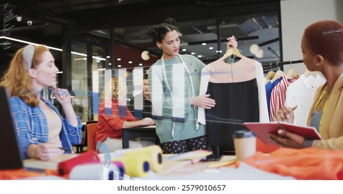 Image of financial data processing over diverse creative business people in office. Global finance, business, connections, computing and data processing concept digitally generated image.