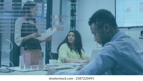 Image of financial data processing over diverse colleagues discussing work in office. Global business, finances, computing and digital interface concept digitally generated image.