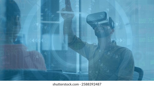 Image of financial data processing over biracial businessman in vt headset in office. Global finance, business, connections, computing and data processing concept digitally generated image.