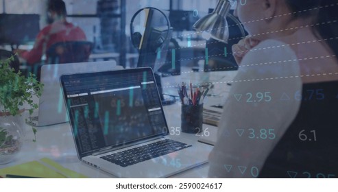 Image of financial data processing over caucasian businesswoman using laptop in office. Global business, finances, computing and digital interface concept digitally generated image.