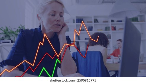Image of financial data processing over caucasian businesswoman using laptop in office. Global finance, business, connections, computing and data processing concept digitally generated image.