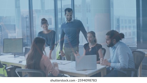 Image of financial data processing over diverse colleagues having meeting in office. Global business, finances and digital interface concept digitally generated image.