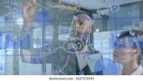 Image of financial data processing over diverse business people in office. Global finance, business, connections, computing and data processing concept digitally generated image.