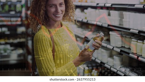 Image of financial data processing over caucasian women shopping. Global shopping, business, finances, data processing and digital interface concept digitally generated image.