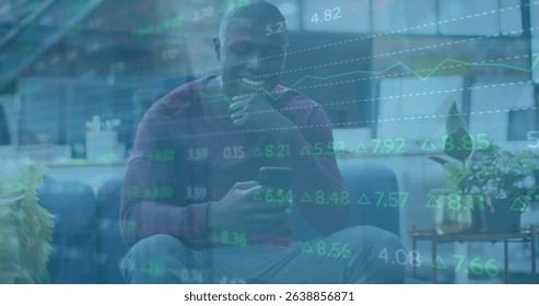 Image of financial data processing over african american businessman using smartphone. Global business, communication, digital interface and data processing concept digitally generated image.