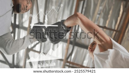 Image of financial data processing over diverse female boxer and male trainer. Global computing, finances, sports, communication and digital interface concept digitally generated image.