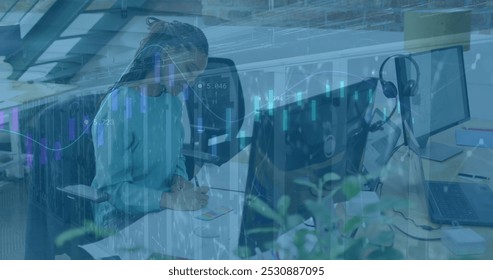 Image of financial data processing and server room over african american businesswoman in office. Global business and digital interface concept digitally generated image. - Powered by Shutterstock