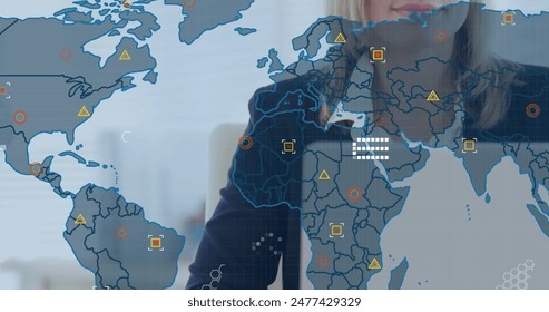 Image of financial data processing with world map over caucasian businesswoman using laptop. Global business, finances, computing and data processing concept digitally generated image.