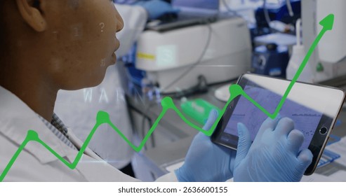 Image of financial graph over female worker using tablet. Global business, finances, data processing and digital interface concept digitally generated image.