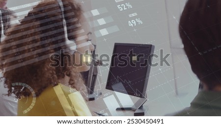 Image of financial graphs and data over happy biracial call center worker. Business, call center, finance, economy and working with technology concept digitally generated image.