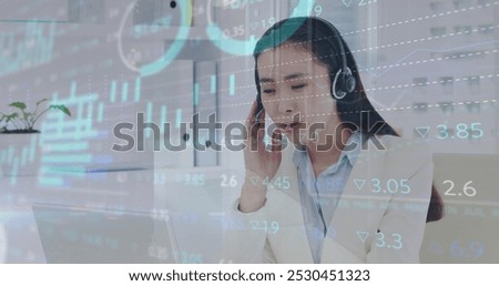 Image of financial graphs and data over asian female call center worker. Business, call center, finance, economy and working with technology concept digitally generated image.