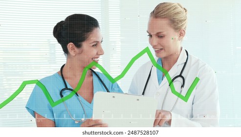 Image of financial graphs over happy caucasian female doctors talking. Health, medicine, finance and economy concept digitally generated image. - Powered by Shutterstock