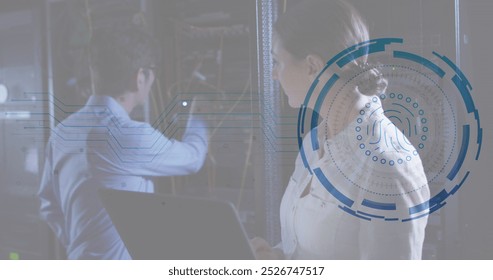 Image of fingerprint scanner against diverse male and female engineers working at server room. Cyber security and business data storage technology concept - Powered by Shutterstock