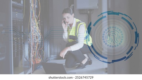 Image of fingerprint scanner over caucasian female engineer talking on smartphone at server room. Cyber security and business data storage technology concept - Powered by Shutterstock