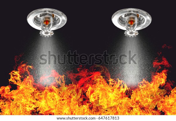 Image of Fire Sprinklers Spraying with fire\
background. Fire sprinklers are part of an overall safety protocol\
for fire and life safety.