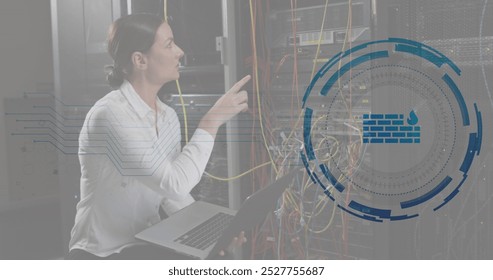 Image of firewall in loading circles, caucasian female engineer checking server using laptop. Digital composite, multiple exposure, protection, data center, networking, technology concept.