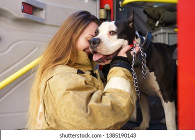 Image Of Firewoman With Dog Standing Near Fire Truck At Station