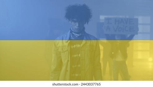 Image of flag of ukraine over african american male protester. ukraine crisis and international politics concept digitally generated image. - Powered by Shutterstock