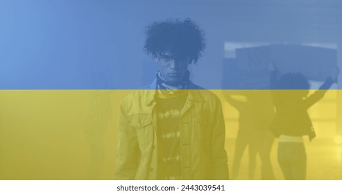 Image of flag of ukraine over african american male protester. ukraine crisis and international politics concept digitally generated image. - Powered by Shutterstock