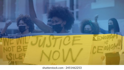 Image of flag of ukraine over diverse female and male protesters in face masks. ukraine crisis and international politics concept digitally generated image. - Powered by Shutterstock