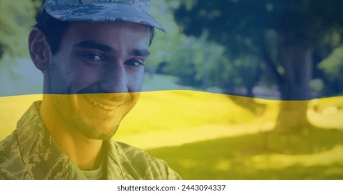 Image of flag of ukraine over happy biracial male soldier. ukraine crisis and international politics concept digitally generated image. - Powered by Shutterstock