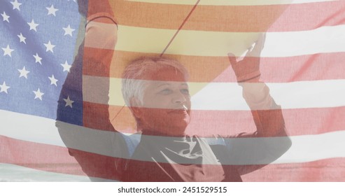 Image of flag of united states of america and senior biracial woman with surfboard on beach. American patriotism, diversity and tradition concept digitally generated image. - Powered by Shutterstock