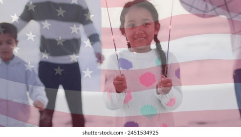 Image of flag of united states of america over biracial girl holding sparklers. American patriotism, diversity and tradition concept digitally generated image. - Powered by Shutterstock