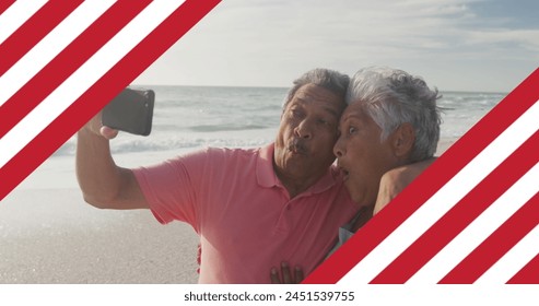 Image of flag of united states of america over senior biracial couple taking selfie on beach. American patriotism, diversity and tradition concept digitally generated image. - Powered by Shutterstock