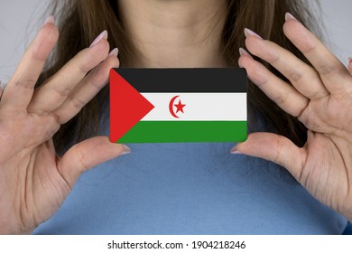 Image Of The Flag Of West Sahara On A Business Card In Female Hands