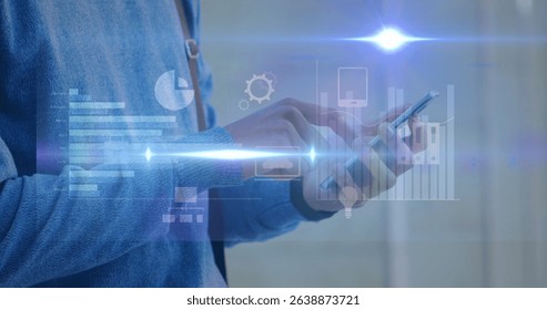 Image of flare with graphs and computer icons over midsection of man using smartphone. Digital composite, multiple exposure, database, communication, futuristic and technology concept.