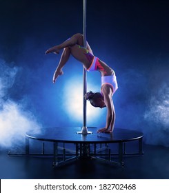 Image of flexible skinny girl dancing on pole