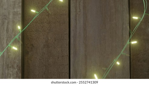 Image of flickering fairy lights with copy space on wooden background. Christmas, tradition and celebration concept digitally generated image. - Powered by Shutterstock