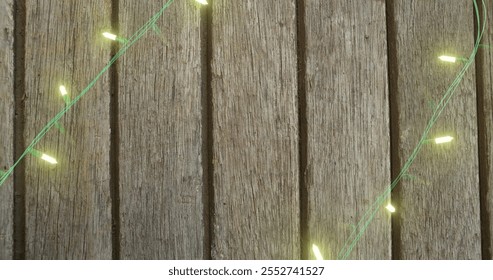 Image of flickering fairy lights with copy space on wooden background. Christmas, tradition and celebration concept digitally generated image. - Powered by Shutterstock