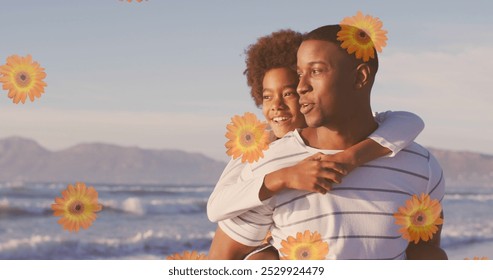 Image of flowers over happy african american father with son on sunny beach. healthy and active beach holiday concept digitally generated image. - Powered by Shutterstock