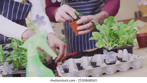 Image of flowers over happy diverse couple planting plants together. Relationship, spring, gardening and lifestyle concept digitally generated image. - Powered by Shutterstock