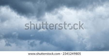 The image of the formidable storm clouds in close-up is sight that commands attention and evokes sense of awe and trepidation. Сlouds loom large, dominating frame with their dark and ominous presence.